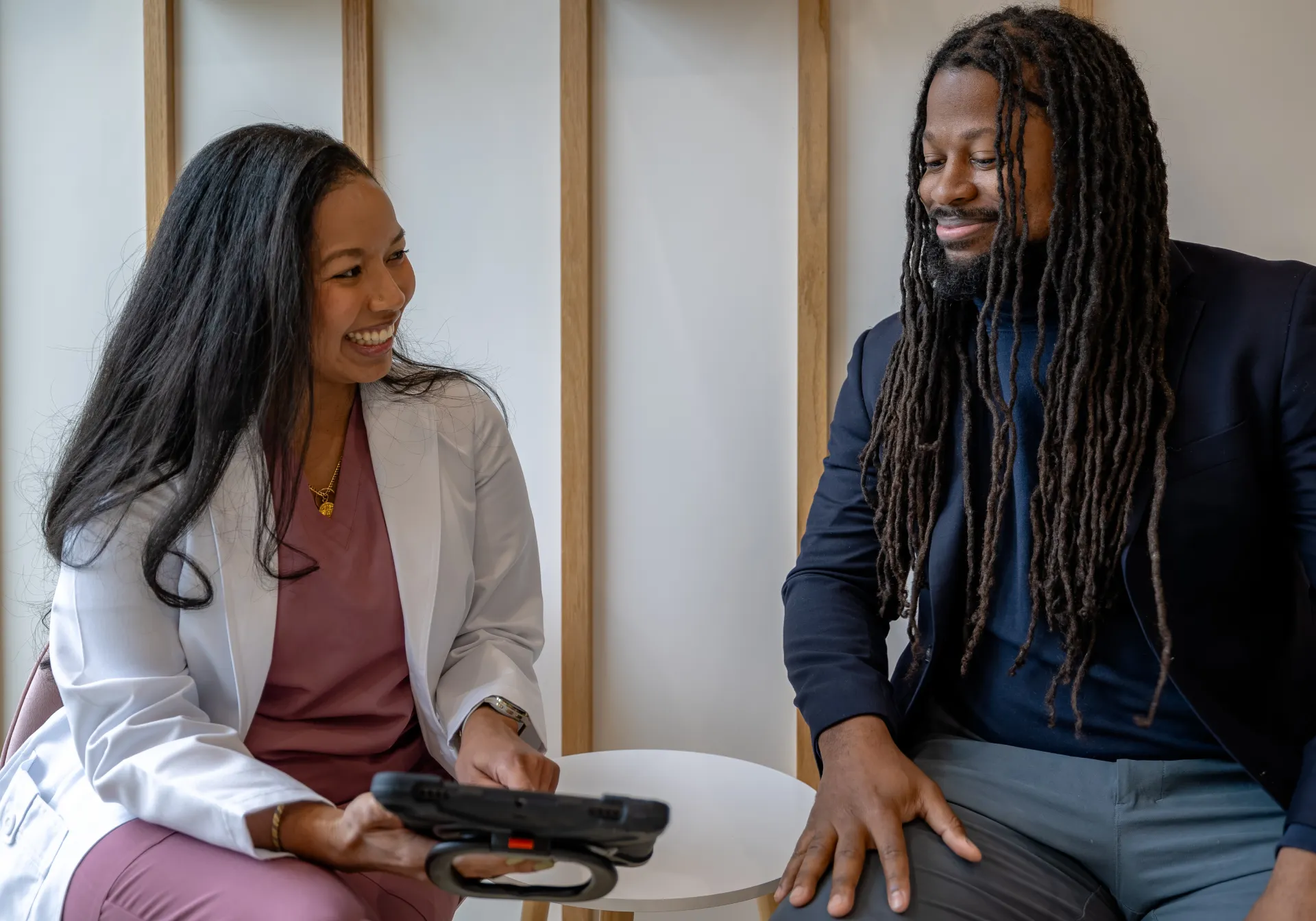 Doctor with patient smiling and having a joyful conversation